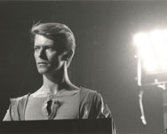 thumbnail link to original Tom Robe photograph of David Bowie on stage behind synthesizer, Isolar II tour Toronto.
