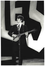 thumbnail link to original 1964 Ken Regan photo of John Lennon on the Ed Sullivan show